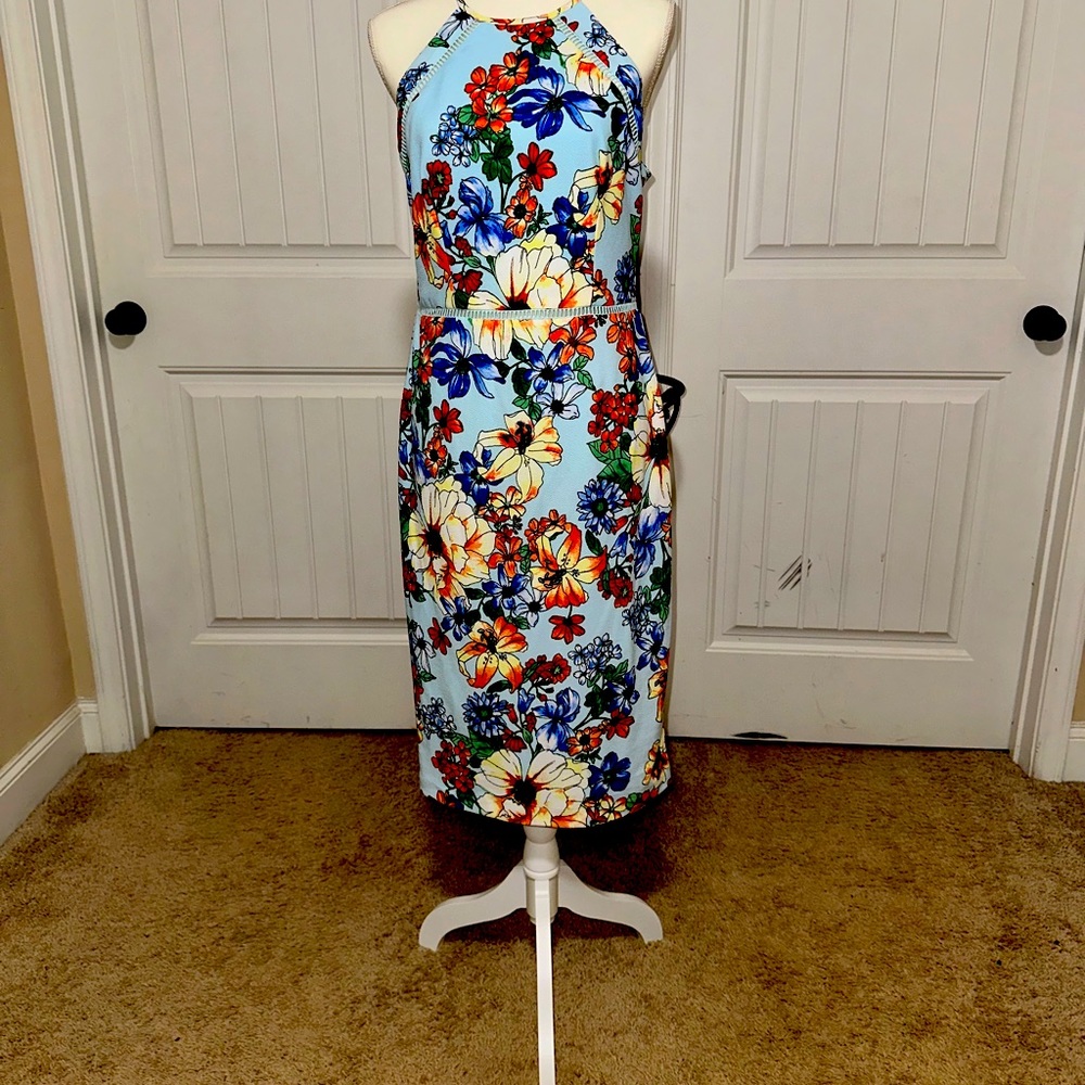 Form fitting. Midi length lightweight halter dress